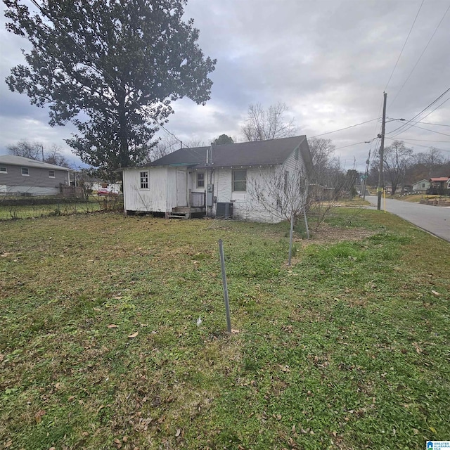 rear view of property with a lawn