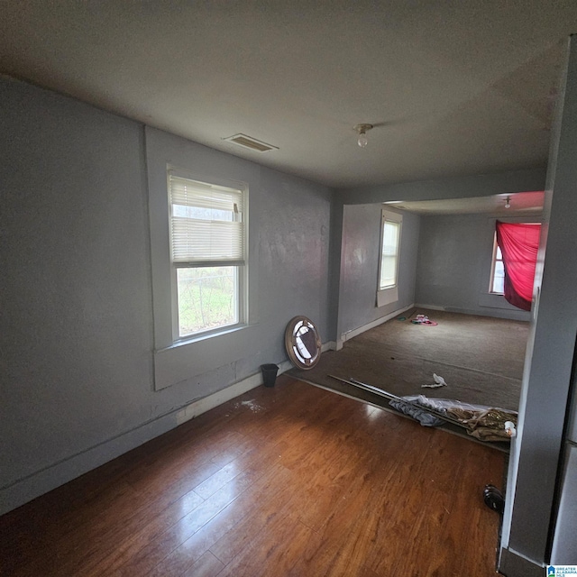 unfurnished room with dark hardwood / wood-style floors