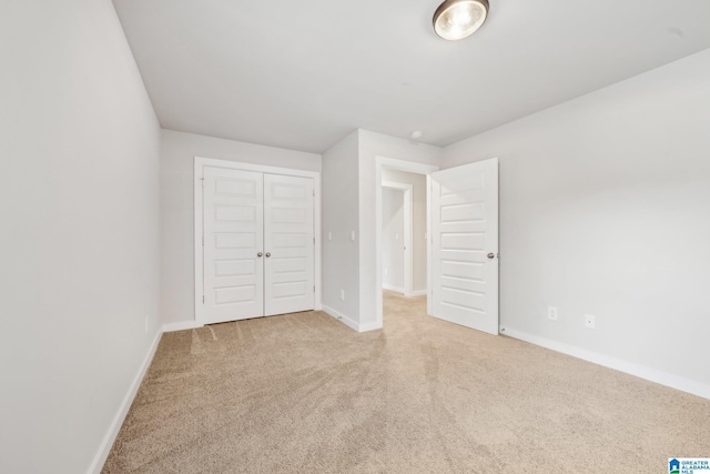 unfurnished bedroom with a closet and carpet floors