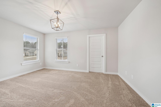 unfurnished room with carpet floors and an inviting chandelier