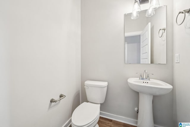 bathroom featuring sink, toilet, and hardwood / wood-style flooring