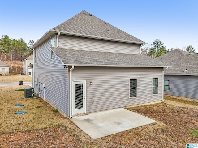 back of house with a yard, central AC unit, and a patio area