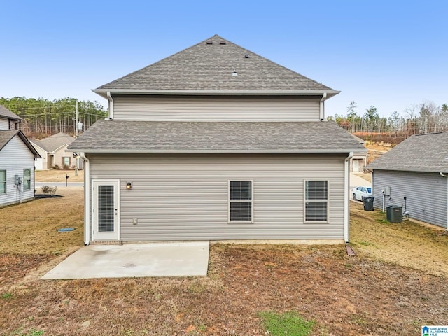 rear view of house with a yard, a patio, and central AC unit