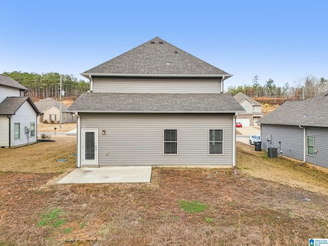 rear view of property with a patio area, a yard, and central AC