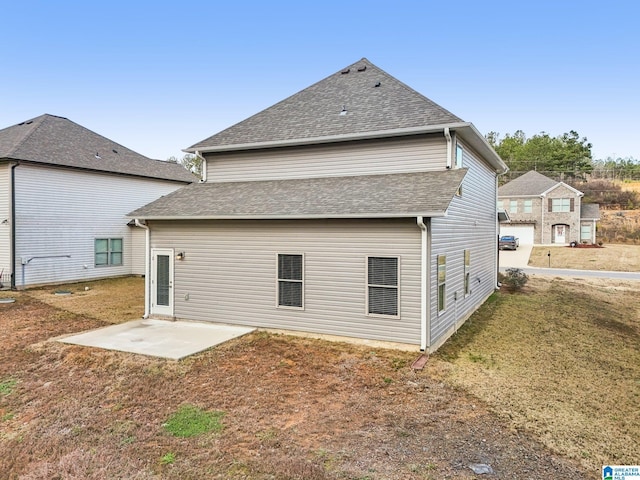 back of property featuring a patio area and a yard