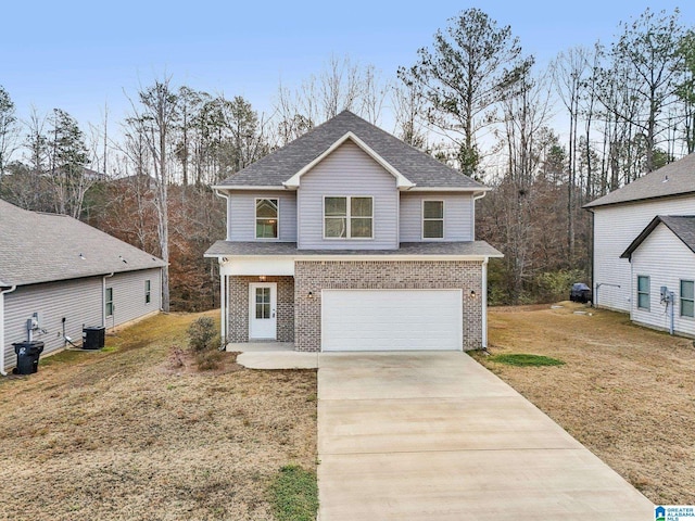 view of property with a front lawn, central AC unit, and a garage