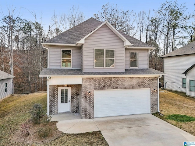 view of front of house with a front yard and a garage