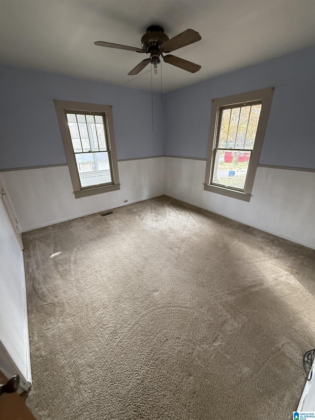 unfurnished room featuring carpet flooring and ceiling fan