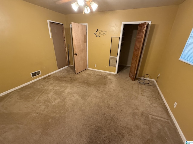 unfurnished bedroom featuring ceiling fan and light carpet