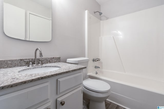 full bathroom with shower / bathing tub combination, hardwood / wood-style floors, vanity, and toilet