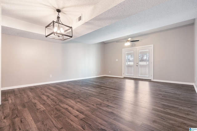 unfurnished room featuring dark hardwood / wood-style floors, a textured ceiling, and french doors