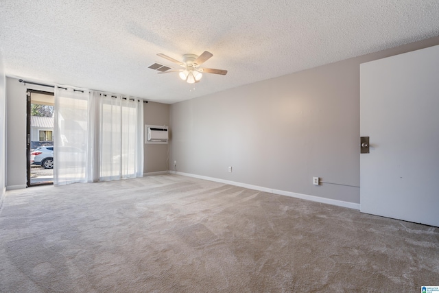 unfurnished bedroom featuring a wall mounted AC, ceiling fan, carpet floors, and a textured ceiling