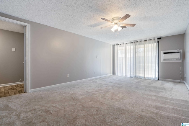 carpeted empty room with a textured ceiling, ceiling fan, and a wall mounted air conditioner