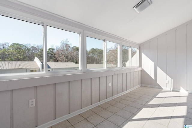 unfurnished sunroom featuring lofted ceiling