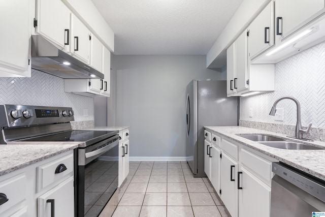 kitchen featuring sink, a textured ceiling, appliances with stainless steel finishes, light tile patterned flooring, and white cabinetry