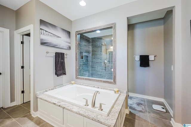 bathroom with tile patterned flooring and separate shower and tub