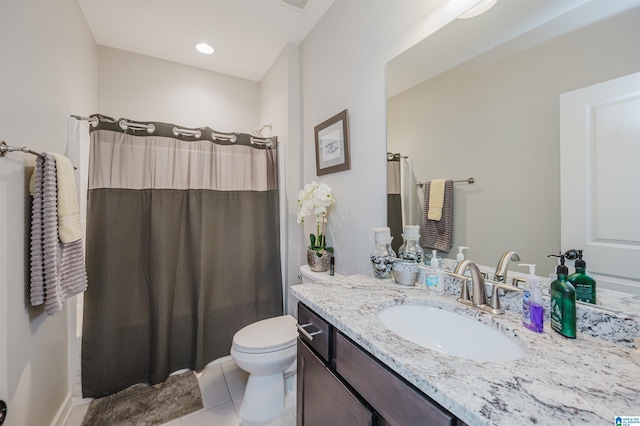 bathroom featuring tile patterned floors, vanity, toilet, and walk in shower