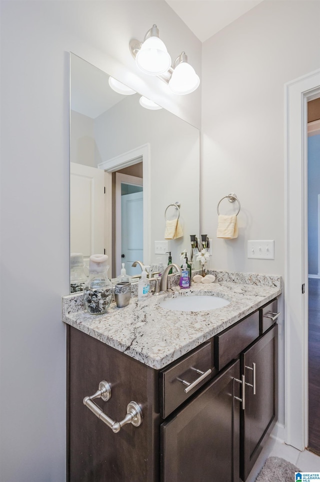 bathroom featuring tile patterned flooring and vanity