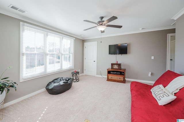 living area with carpet flooring, a wealth of natural light, and crown molding