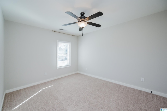 spare room featuring ceiling fan and carpet floors