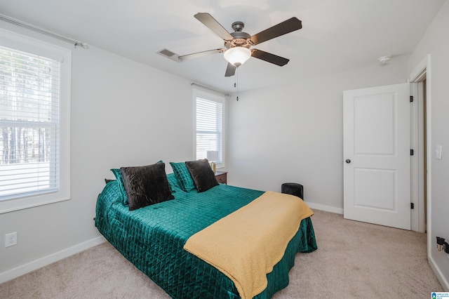 bedroom with light colored carpet and ceiling fan