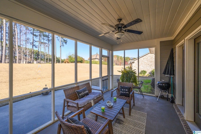 sunroom / solarium featuring ceiling fan and wood ceiling