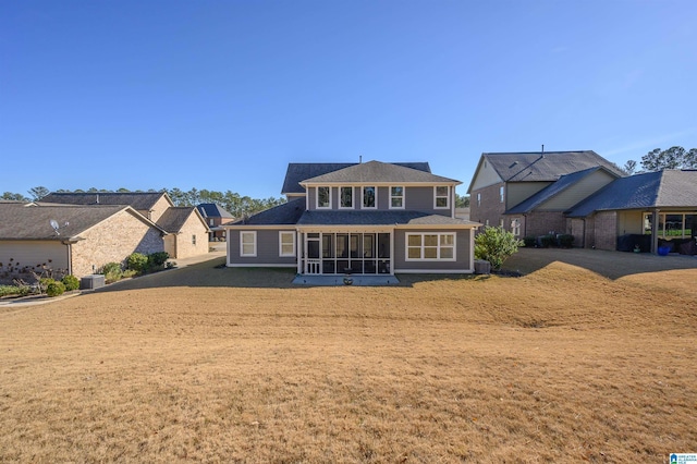 rear view of house featuring a sunroom