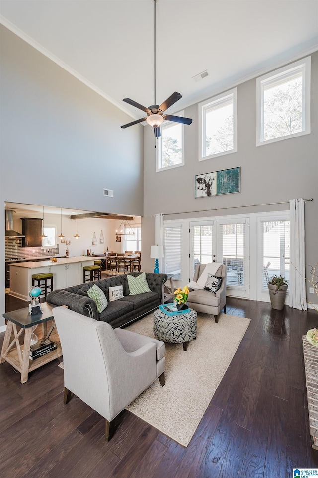 living room featuring a high ceiling, french doors, ceiling fan, and hardwood / wood-style floors