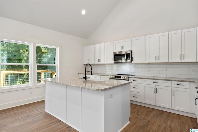 kitchen with tasteful backsplash, appliances with stainless steel finishes, and white cabinets