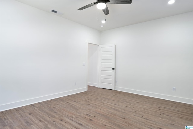 spare room featuring hardwood / wood-style floors and ceiling fan