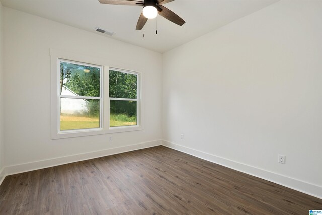 empty room featuring dark wood-type flooring and ceiling fan