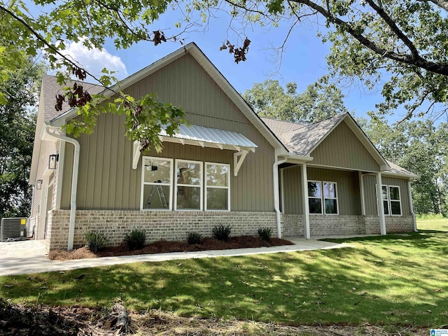 craftsman-style house featuring a front yard and central air condition unit