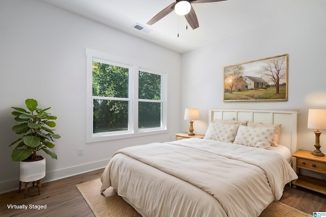 bedroom with ceiling fan and dark hardwood / wood-style flooring