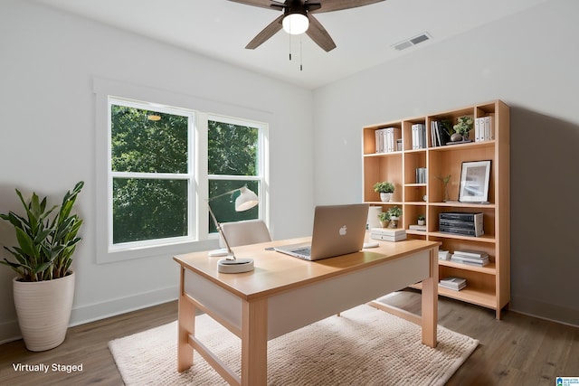 home office featuring ceiling fan and dark hardwood / wood-style floors