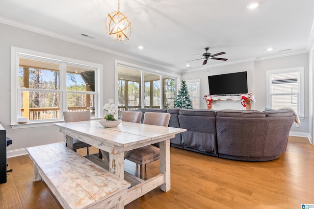 dining area featuring hardwood / wood-style flooring, a healthy amount of sunlight, and ornamental molding