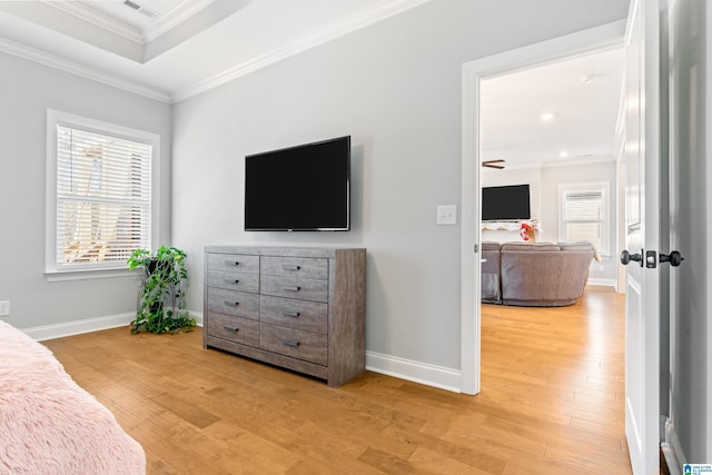 bedroom with light hardwood / wood-style floors and crown molding