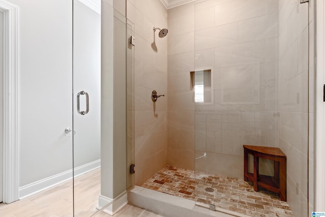 bathroom with crown molding and walk in shower