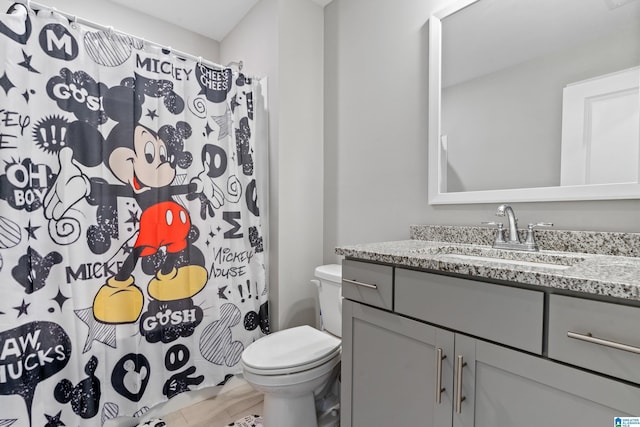 bathroom with tile patterned floors, vanity, a shower with shower curtain, and toilet