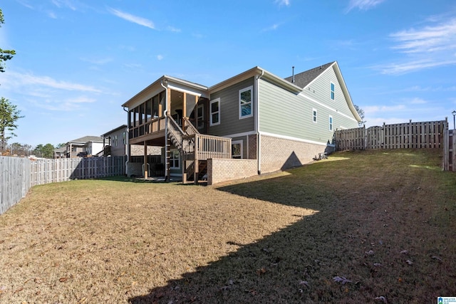 back of house featuring a sunroom and a yard