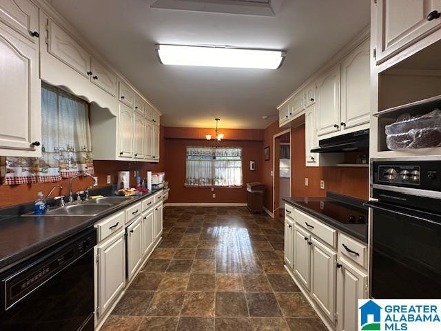 kitchen featuring black appliances, sink, and a chandelier