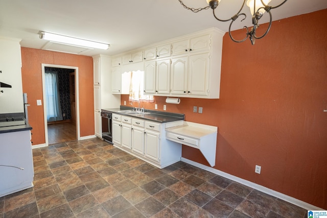 kitchen with dishwasher, white cabinets, a notable chandelier, and sink