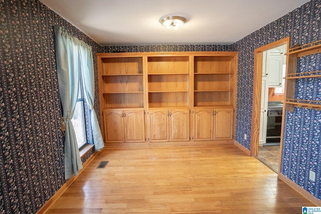 unfurnished dining area with light hardwood / wood-style flooring