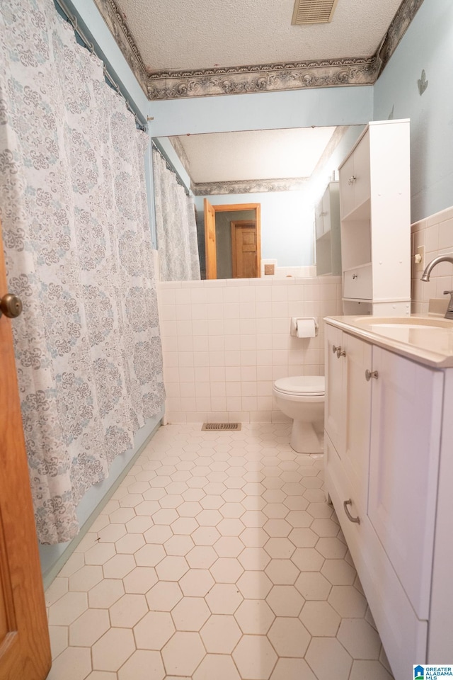 bathroom featuring tile patterned flooring, toilet, tile walls, and curtained shower