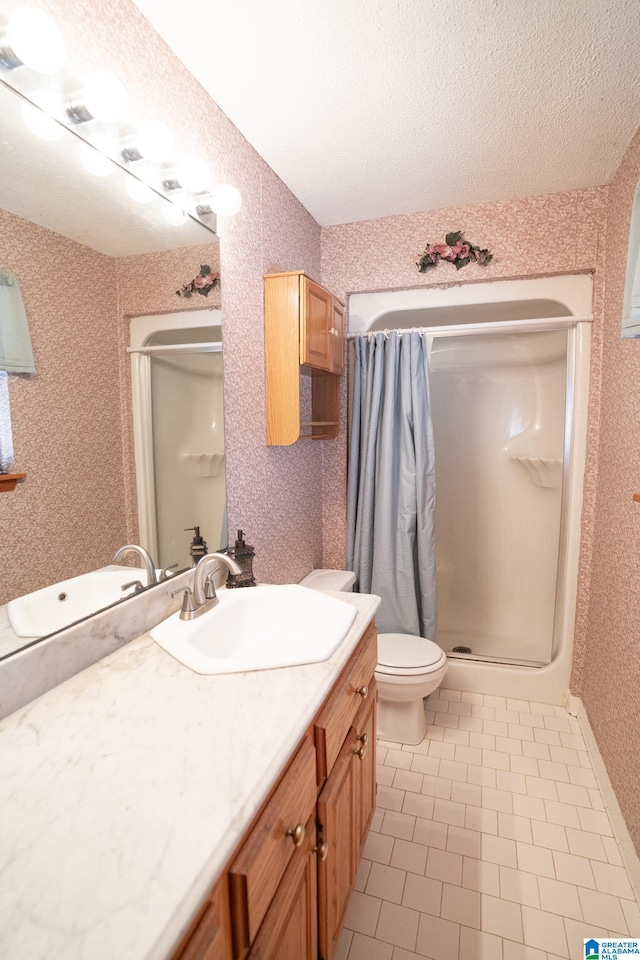 bathroom featuring vanity, tile patterned floors, toilet, walk in shower, and a textured ceiling