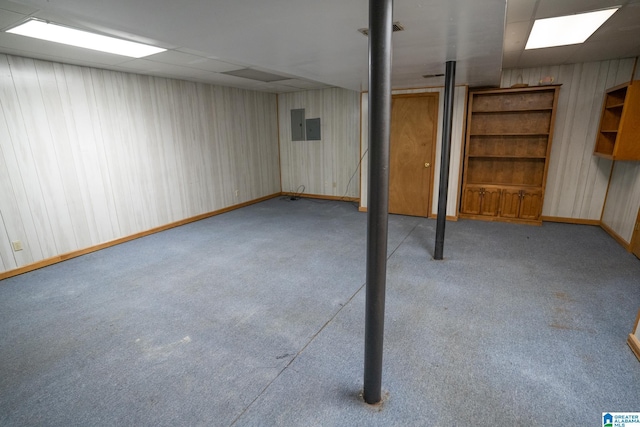 basement featuring electric panel and light colored carpet