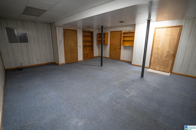 basement with electric panel, light carpet, and a drop ceiling