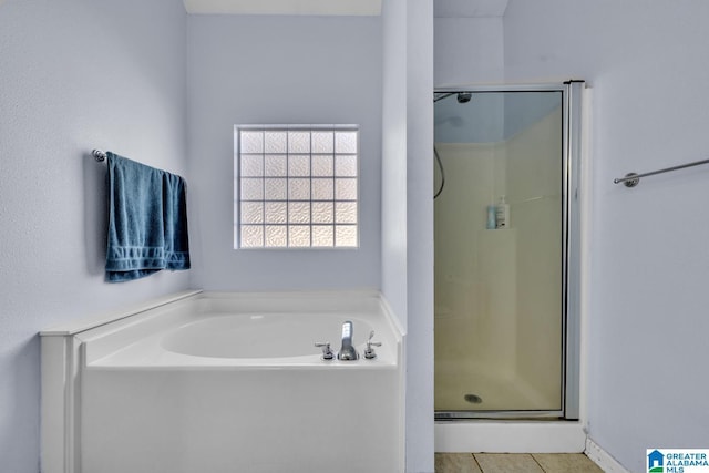 bathroom with tile patterned floors and plus walk in shower