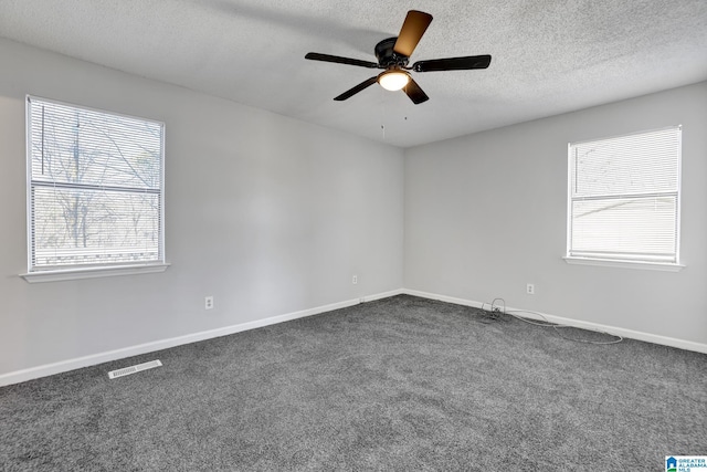 carpeted empty room with a textured ceiling and ceiling fan