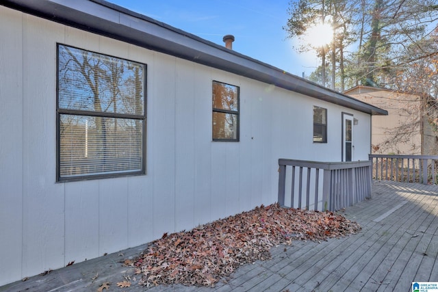 view of side of property featuring a wooden deck