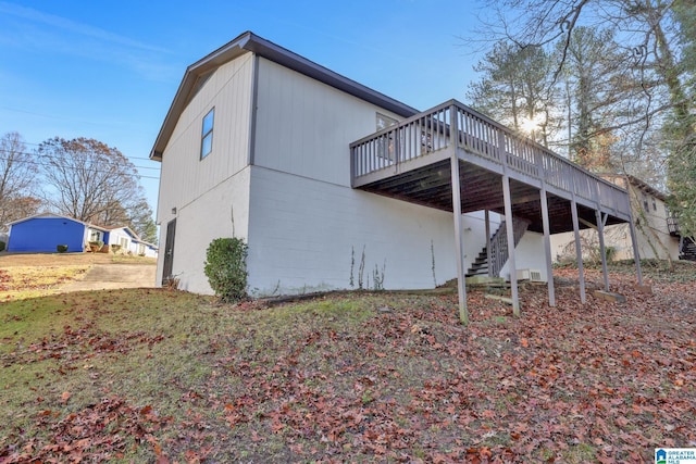 rear view of property featuring a wooden deck